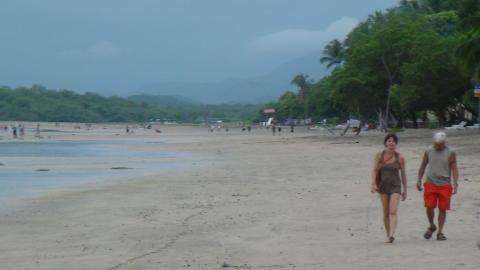 A Couble Walking Along the Beach