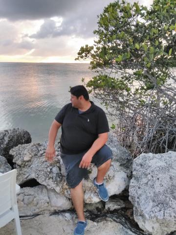 Jorge Campos Sitting on the Rock By The Beach at Gilbert's Resort 2-24-2018
